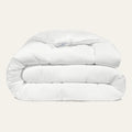 White comforter on a light gray background