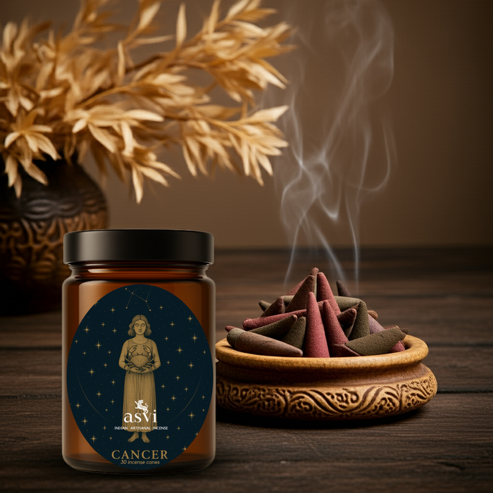 A lit Cancer zodiac incense cone releasing a calming floral scent to promote emotional intelligence and a peaceful home.