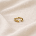 Gold ring on a beige fabric background