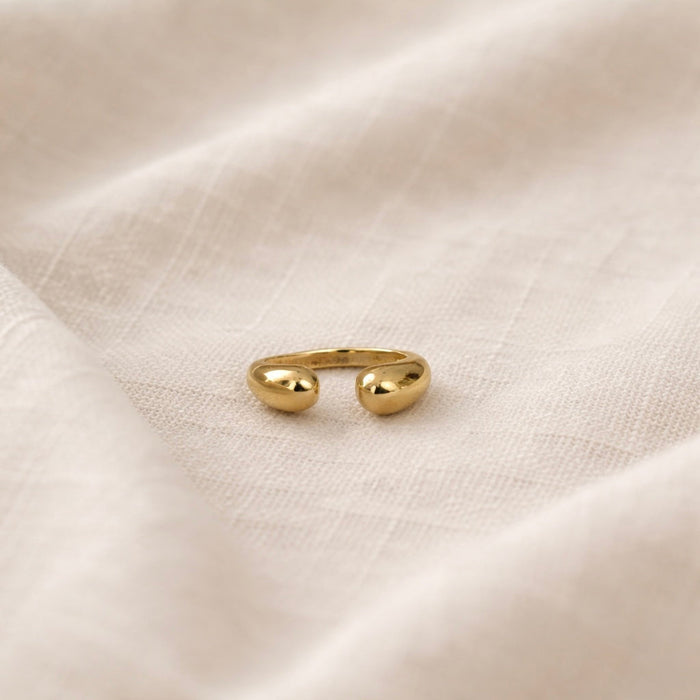 Gold ring on a beige fabric background