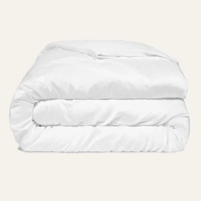 White comforter on a beige background