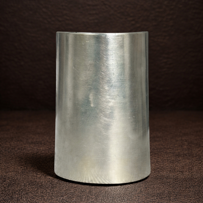 Metallic cylindrical object on a brown textured background