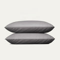 Two gray pillows stacked on a white background