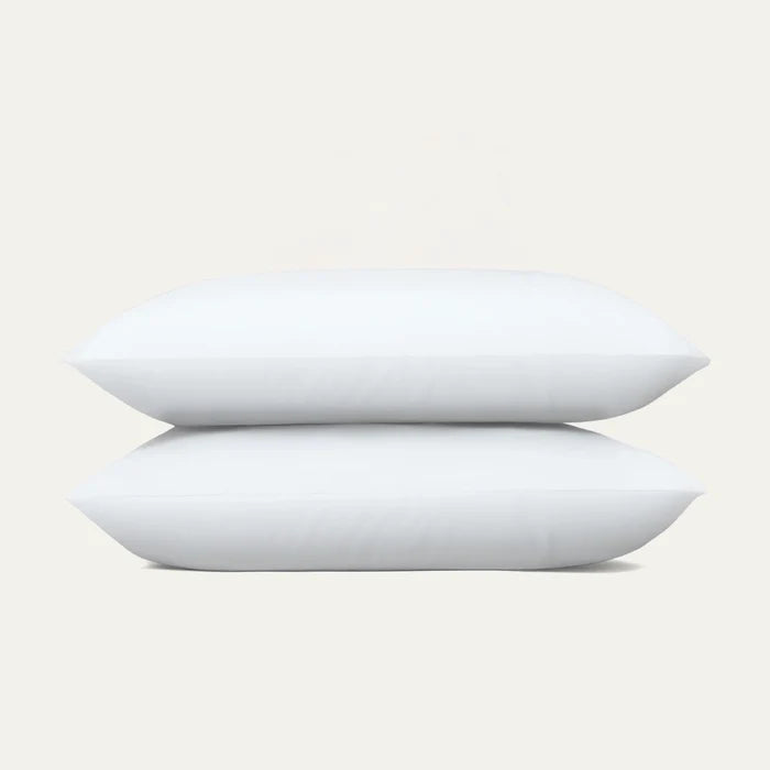 Two white pillows stacked on a light gray background