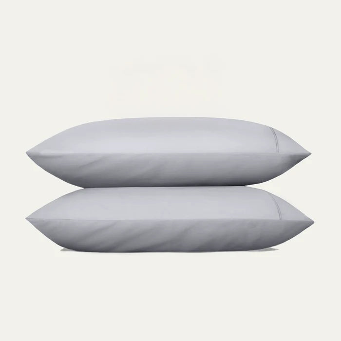 Two light gray pillows on a white background