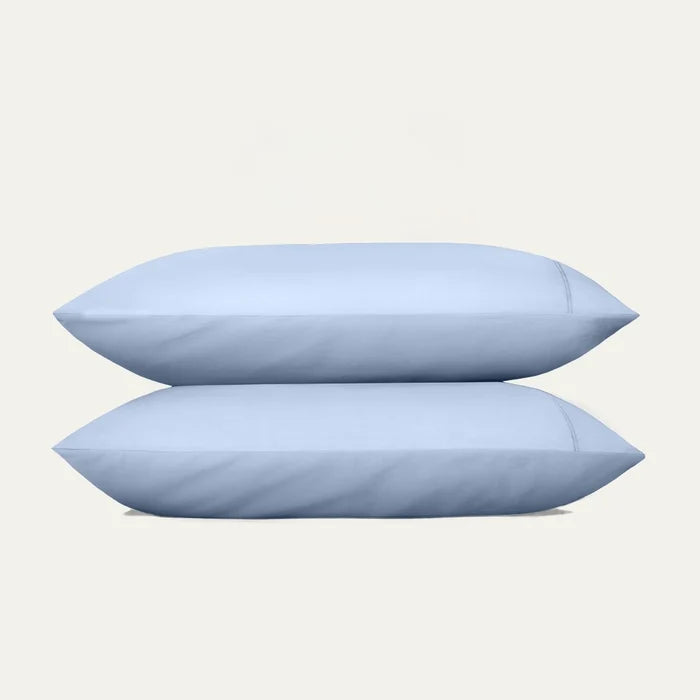 Two light blue pillows on a white background