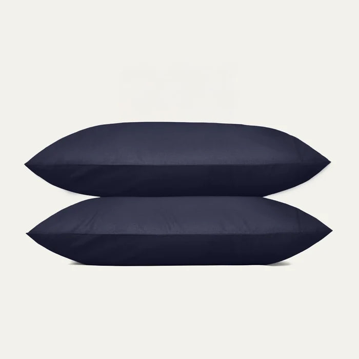 Two navy blue pillows on a light gray background