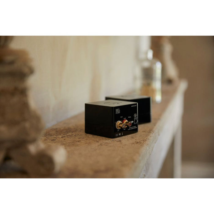 REL HT-Air MKII Wireless Transmitter, Black, lifestyle, on a stone mantel