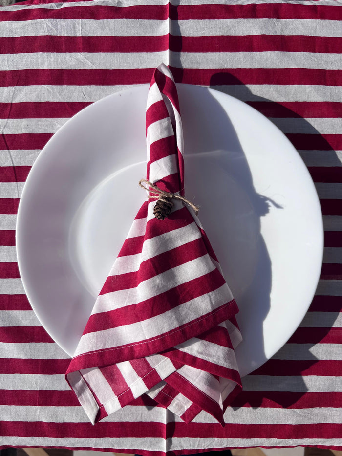 Close-up of the 100% pure linen texture and the artisan 'perfect imperfections' of the hand-printed red stripes.