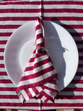 Close-up of the 100% pure linen texture and the artisan 'perfect imperfections' of the hand-printed red stripes.