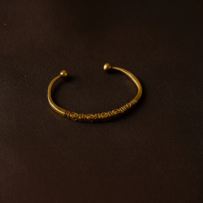 Bronze bracelet on a dark brown background