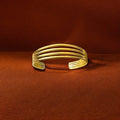 The Tolu four-band brass bracelet by Oriaku Studio, a minimalist cuff representing unity and togetherness.