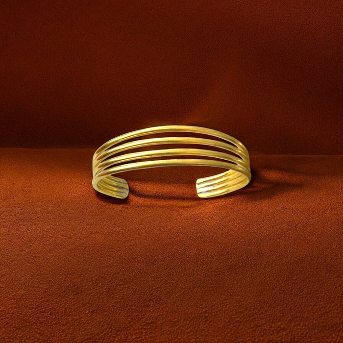 The Tolu four-band brass bracelet by Oriaku Studio, a minimalist cuff representing unity and togetherness.