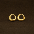 Pair of gold hoop earrings on a brown background